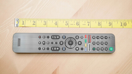 Remote controller beside the measuring tape to measure manhood size