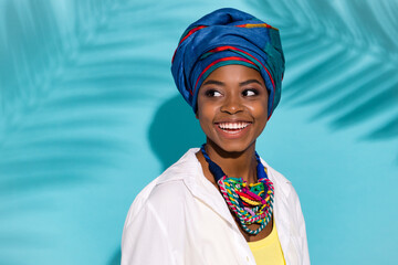 Photo of pretty lady in kongo outfit jewelry look empty space enjoy theme carnival isolated cyan color background