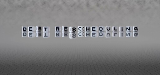 debt rescheduling word or concept represented by black and white letter cubes on a grey horizon background stretching to infinity