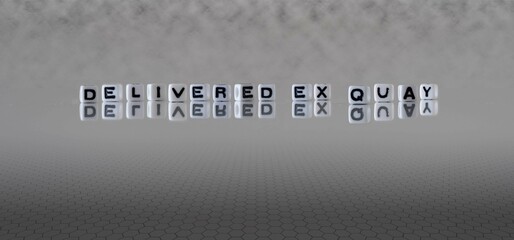 delivered ex quay word or concept represented by black and white letter cubes on a grey horizon background stretching to infinity