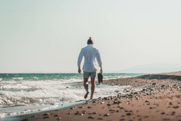 A BOY'S WALK ON THE SHORE OF THE BEACH