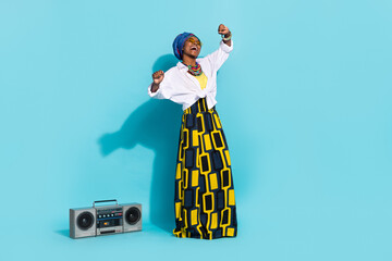 Photo of zulu lady enjoy aborigine song sound dance boom box wear tradition outfit isolated teal...