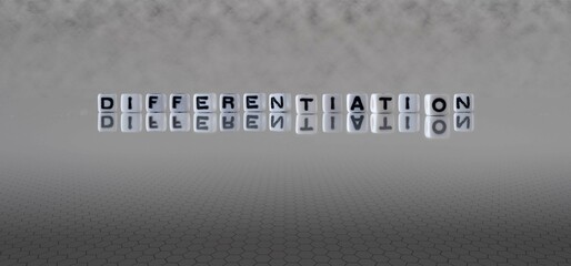 differentiation word or concept represented by black and white letter cubes on a grey horizon background stretching to infinity - obrazy, fototapety, plakaty