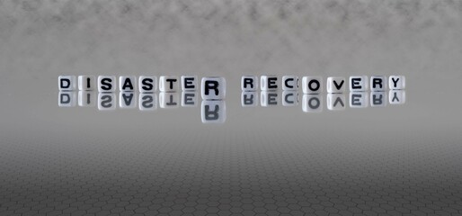 disaster recovery word or concept represented by black and white letter cubes on a grey horizon background stretching to infinity