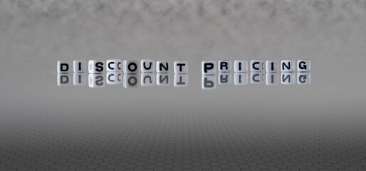 discount pricing word or concept represented by black and white letter cubes on a grey horizon background stretching to infinity