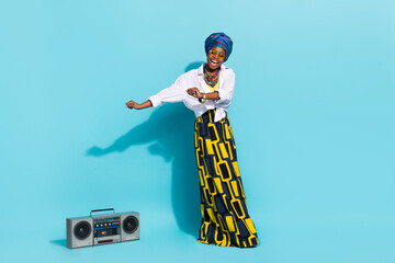 Photo of lady masai tribe dance dynamic boom box wear aborigine clothes headwrap isolaed teal color...