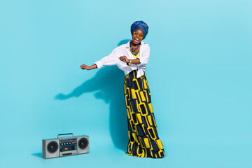 Photo of lady masai tribe dance dynamic boom box wear clothes headwrap isolaed teal color background