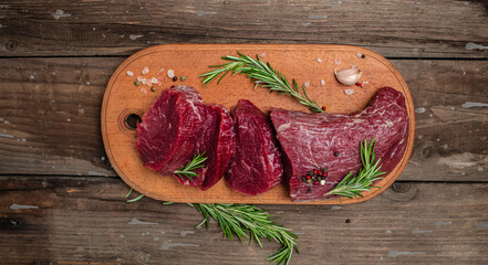 Beef Tenderloin fillet with rosemary and spices. Preparing fresh beef steak ready to cook, Long banner format. Restaurant menu, dieting, cookbook recipe. place for text. top view