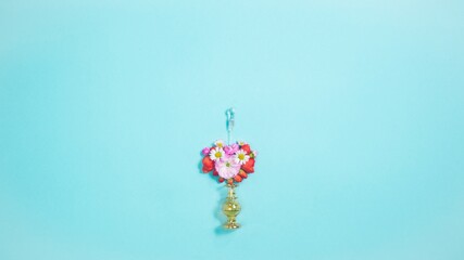 Flower composition in the form of a heart on the tip of glass rod, located above bottle. Symbol of...