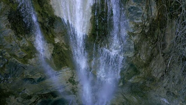 Water falling in deep gorge waterfall