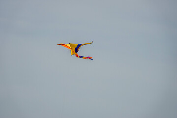 multi coloured kite flying across a hazy sky