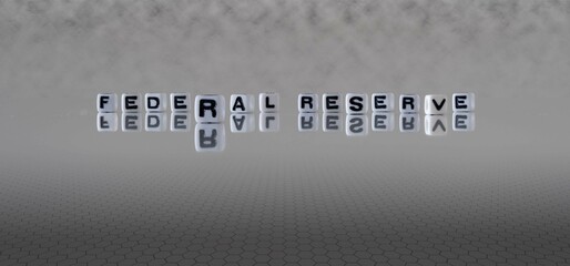 federal reserve word or concept represented by black and white letter cubes on a grey horizon background stretching to infinity