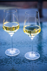 2 wine glasses on glass table, balcony