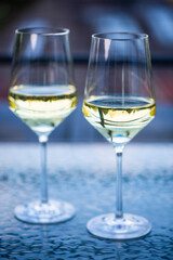 2 wine glasses on glass table, balcony