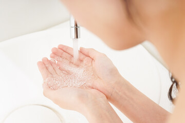 Young woman washing face
