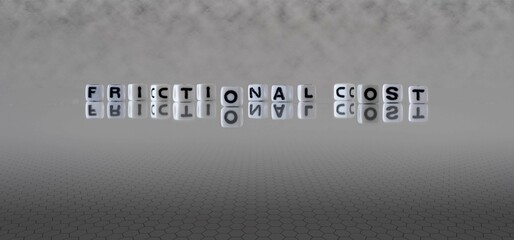 frictional cost word or concept represented by black and white letter cubes on a grey horizon background stretching to infinity