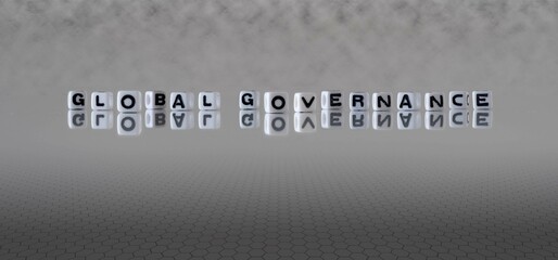 global governance word or concept represented by black and white letter cubes on a grey horizon...