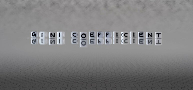 gini coefficient word or concept represented by black and white letter cubes on a grey horizon background stretching to infinity