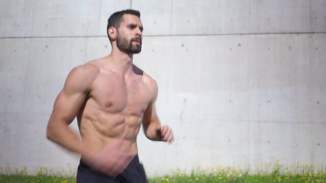 Closeup shot of athletic man doing skip up exercise outdoors