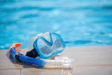 Scuba diving mask nearl swimming pool on vacation at resort. Summer sunny day