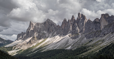 Fototapeta na wymiar Odle mountain massif, Puez-Odle nature park, Dolomites, Italy-August 20, 2015: Hikers crossing Brogles pass on the way from Brogles refuge back to Ortisei village in Gardena valley