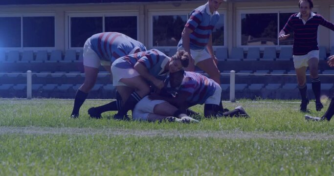 Animation of spots lights moving over diverse team of rugby players during game in field