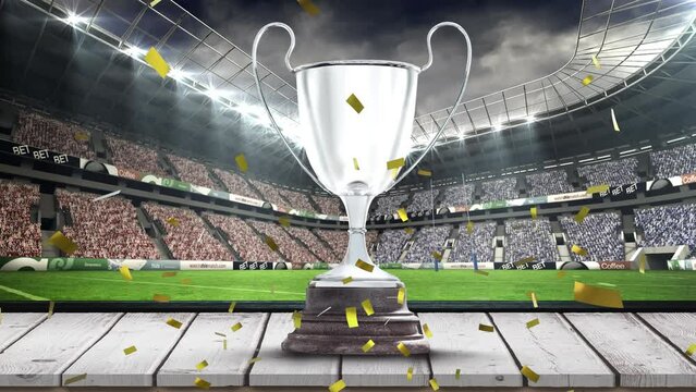 Animation of confetti falling over silver cup in sports stadium