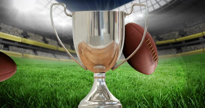 Animation of silver cup and rugby balls in sports stadium