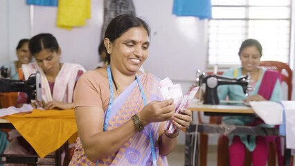 Happy smiling small business garments owner counting money at shop - conept of woman employment, earnings, financial and banking support - Powered by Adobe