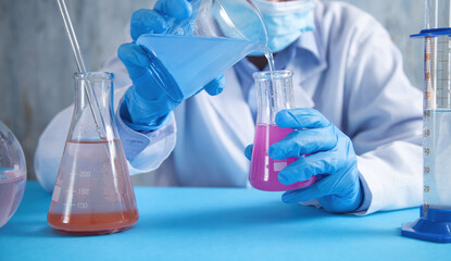 Girl working with flask in a laboratory.