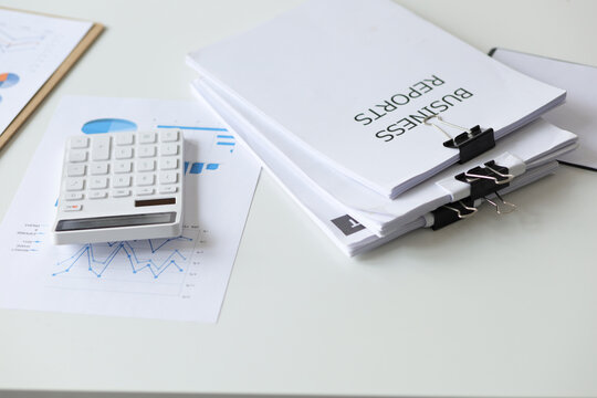 Close-up of business reports with calculators in the office.