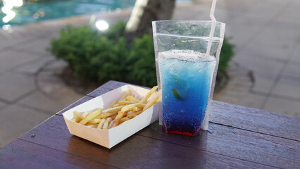 Blue juice with fries at pool side                    