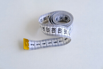 close-up of white centimeter measuring tape, top view, concept of weight control, human physical health, diet and nutrition, lose weight