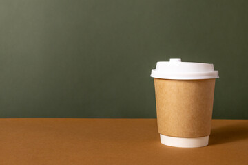 Coffee craft paper cups with place for logo on green and brown background, natural color, for menu and restaurants 