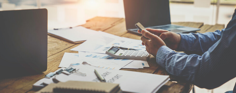 Businessman Working On Desk Office With Using A Calculator To Calculate The Numbers, Finance Accounting Concept