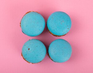 French macaroons on a pink background. Macarons with dor blue and pear. French dessert. Sweet table.Copy space.Place for text.