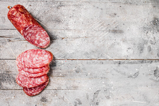 Delicious salami sausage on the table. On a gray background. High quality photo