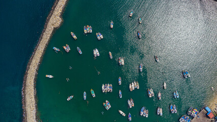Fototapeta na wymiar Colorful fishing boats in the ocean, shot from above, sea landscape.