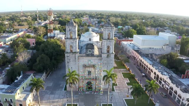 Iglesia De San Servacio Cathedral in Valladolid Mexico down town main city square. symmetrical aerial video footage shot, camera zooms in on the cathedral between the towers. Valladolid Mexico 