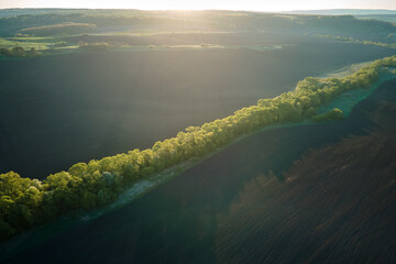 Aerial view of plowed agricultural fields with cultivated fertile soil prepared for planting crops...