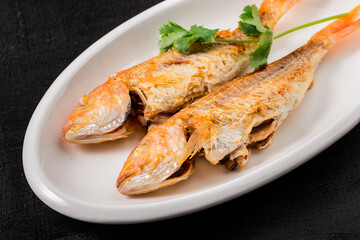 A plate of fried red shirted fish