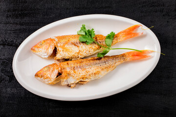 A plate of fried red shirted fish