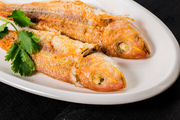 A plate of fried red shirted fish