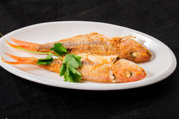 A plate of fried red shirted fish