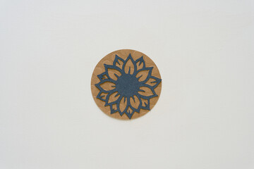 blue paper flower stencil/cutout on a brown paper circle