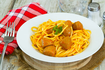 spaghetti with meatballs in a white plate