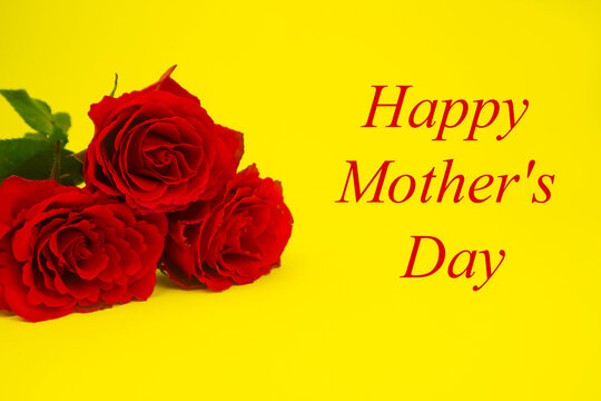 Red roses for mom on a yellow background, text HAPPY MOTHER'S DAY. The concept of a gift, congratulation, gratitude, postcard, surprise. High quality photo
