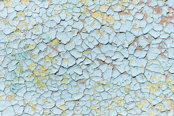 Blue old faded cracked painted surface pattern on building exterior interior wall with aged scratched paint layers. Abstract old plaster stucco imperfection background. Grunge scratched wallpaper