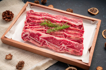Raw Cross Cut Short Ribs beef on wooden plate, Beef Short Ribs (Sliced) on wooden background.