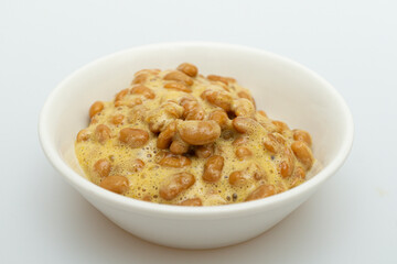 Delicious looking natto in a bowl on a white background